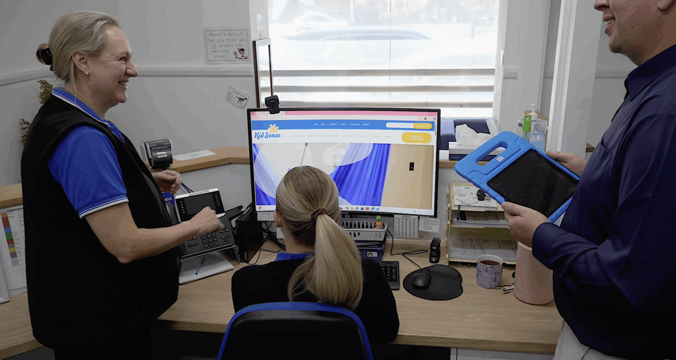 Kids Sense Employee in front of computer